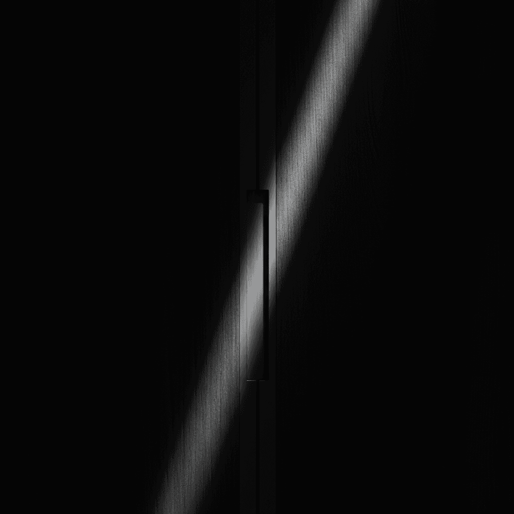 Extreme close-up of a brushed aluminium door handle inset on a dark wood-grain wardrobe door