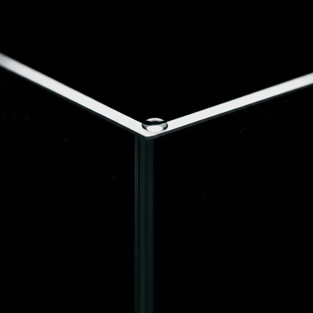Detail of thick frameless glass edge and water droplet